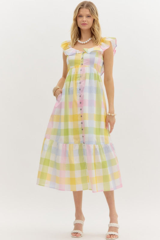 Woman wearing pastel plaid midi dress with ruffle sleeves and front buttons, summer fashion