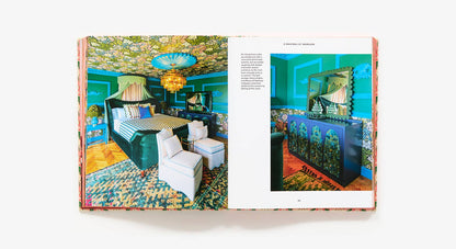 Open book showing a colorful interior design layout with furniture and decor.