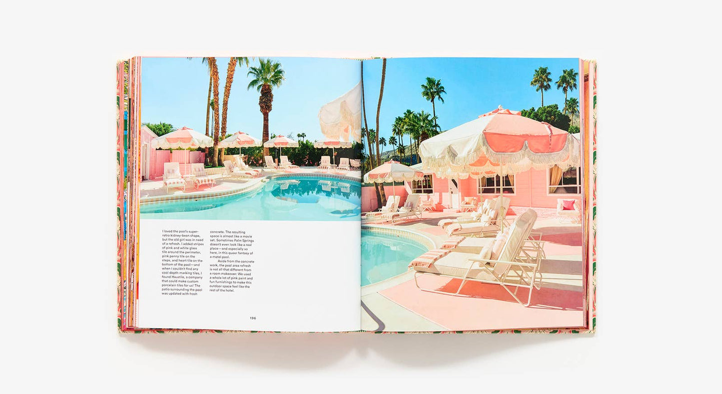 Open book showing a poolside scene with pink cabanas and palm trees.