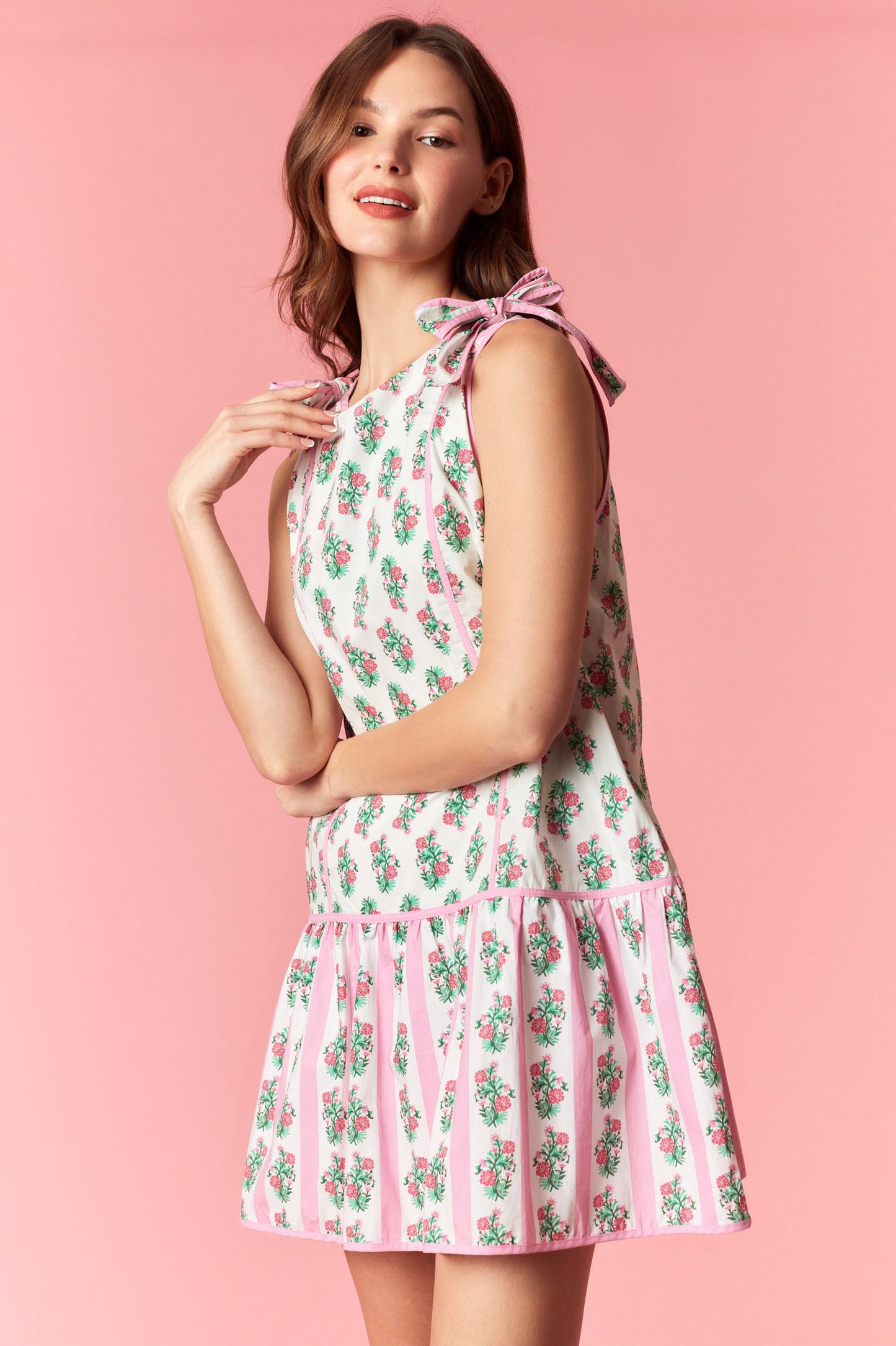 Pink floral tie shoulder mini dress with drop waist hem and pastel stripe detail