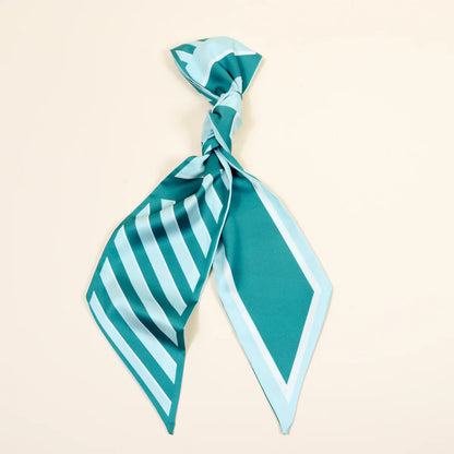 Teal and light blue striped scarf on a beige background