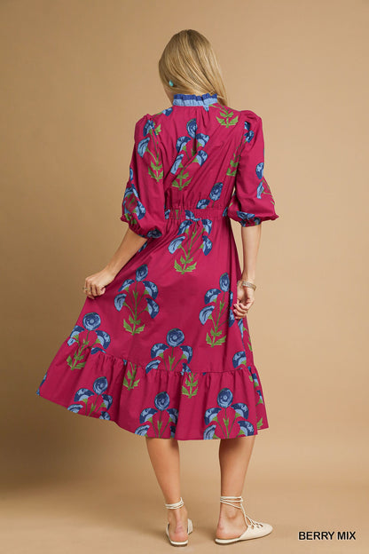 Back view of berry mix floral midi dress with blue collar detail, gathered waist, and tiered hem — bold and colorful boutique dress.
