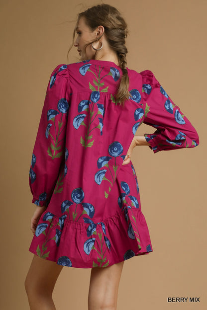 Back view of a berry pink long sleeve floral babydoll dress with blue flower print and ruffle hem — feminine boutique dress from Milo & Lily Boutique.