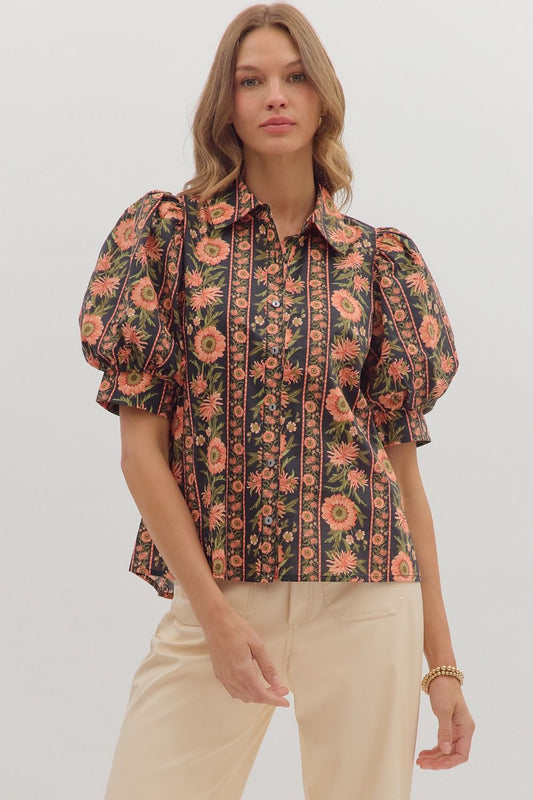 Model wearing a black puff sleeve blouse with coral and olive floral print and button front — elegant boutique top from Milo & Lily