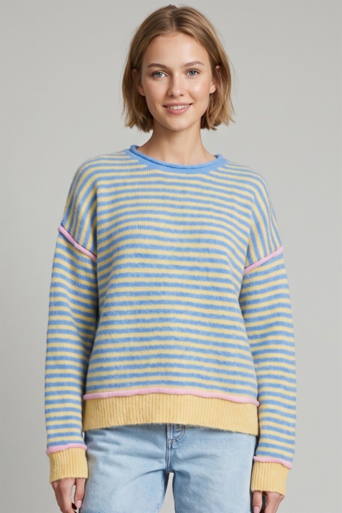 Front view of blue and pale yellow striped sweater with pink trim and ribbed yellow cuffs.