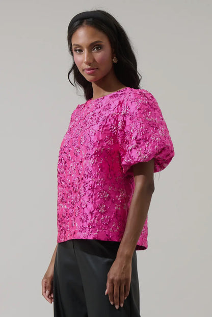 Side view of bright pink metallic embroidered blouse with puff sleeves — chic elevated look from Milo & Lily Boutique.