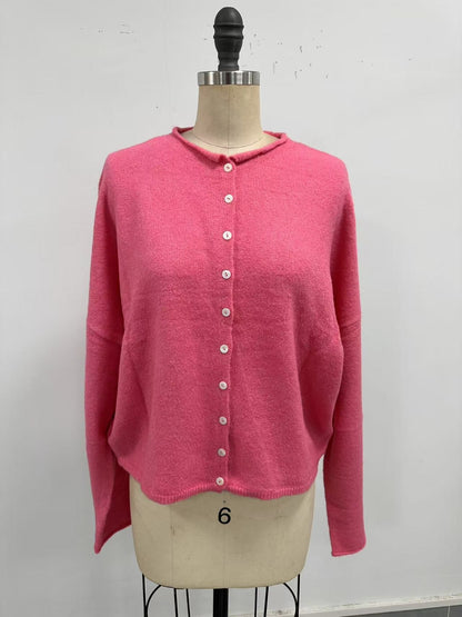Pink cardigan on a mannequin against a white background