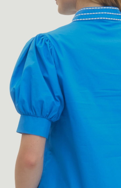 Blue embroidered blouse for women with puff sleeves and white neckline detail, relaxed fit summer top styled with denim