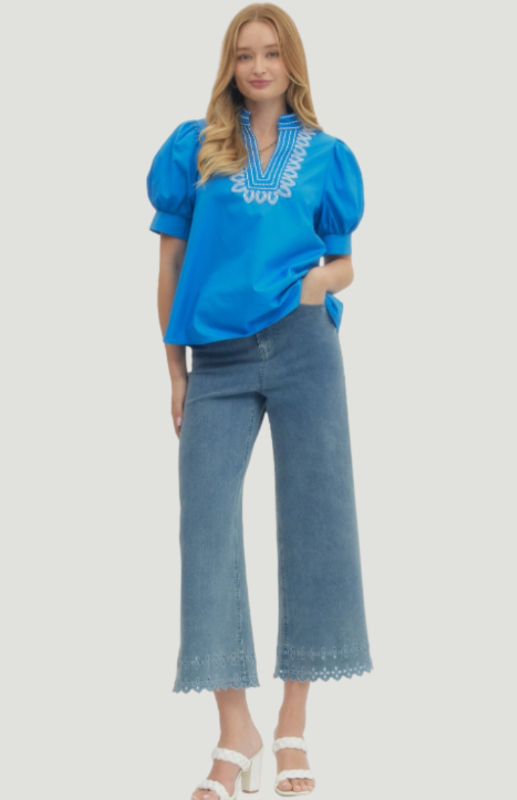 Blue embroidered blouse for women with puff sleeves and white neckline detail, relaxed fit summer top styled with denim