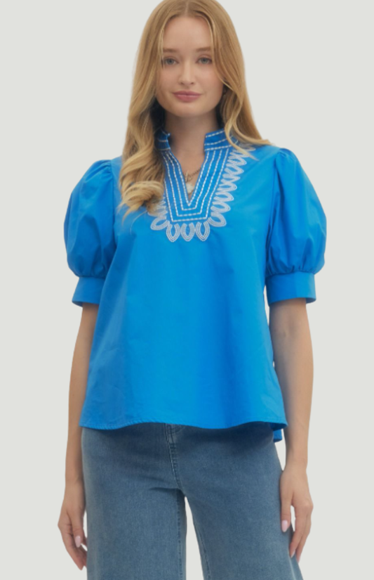 Blue embroidered blouse for women with puff sleeves and white neckline detail, relaxed fit summer top styled with denim