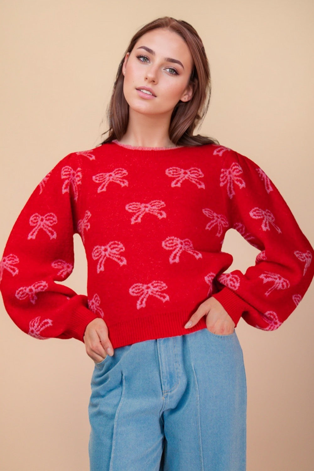 Front view of red Christmas bow sweater featuring pink embroidered bows and ribbed cuffs — festive boutique knit from Milo & Lily.