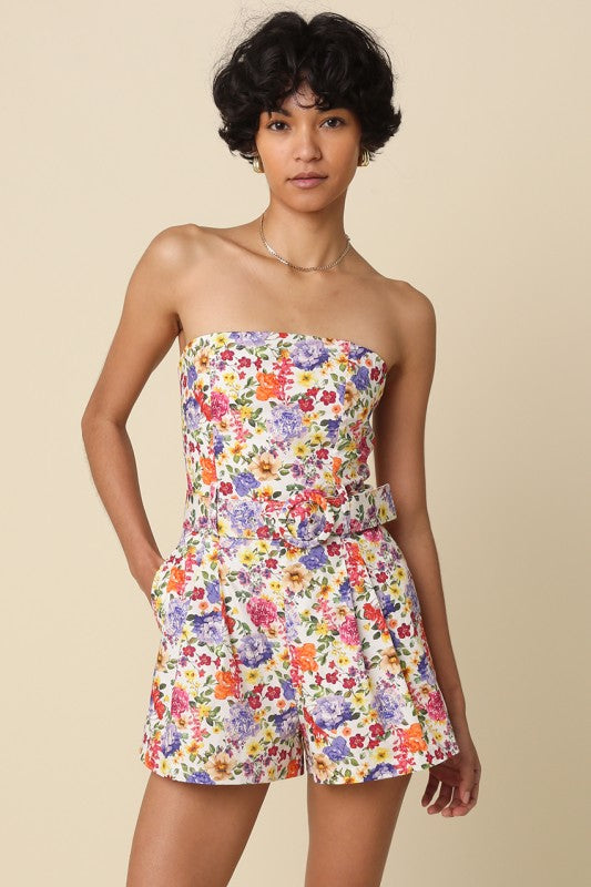 Woman wearing a strapless floral dress on a beige background