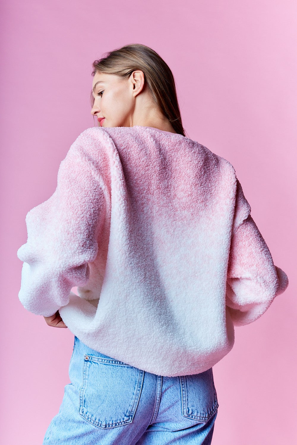 Back view of pink ombre sherpa sweatshirt showing gradient fade