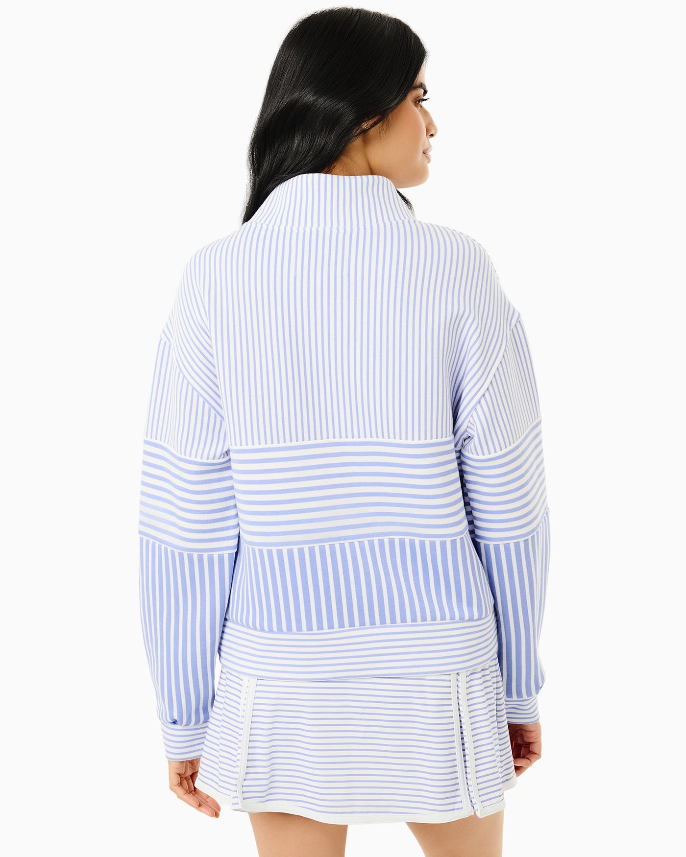 Woman wearing a blue and white striped outfit on a white background