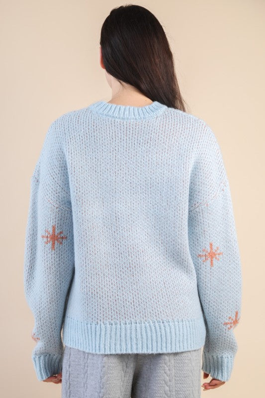 Back view of The Cozy Cowgirl Sweater in soft powder blue with peach star accents on sleeves.
