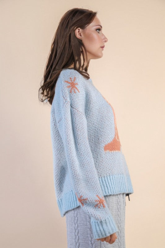 Side angle of The Cozy Cowgirl Sweater showing relaxed fit, peach boot design, and star embroidery on sleeve.