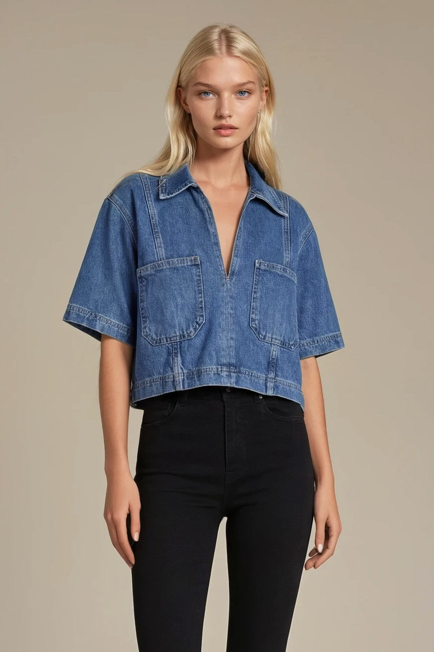 Woman wearing a blue denim shirt with a beige background