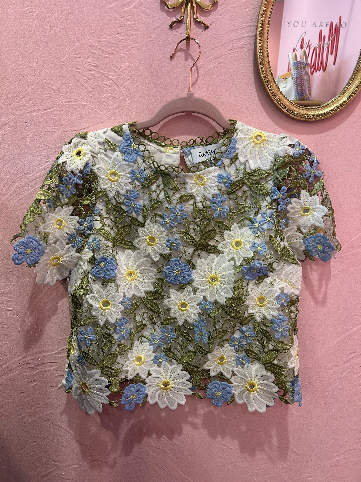 White embroidered daisy lace top with blue floral accents and scalloped hem boutique blouse