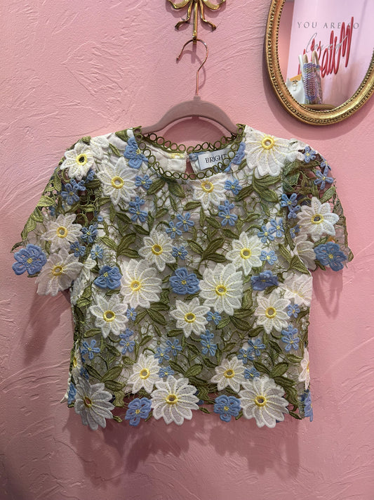White embroidered daisy lace top with blue floral accents and scalloped hem boutique blouse