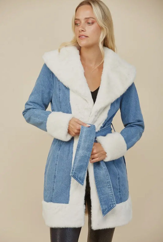 Model wearing a light blue denim coat with soft white faux fur trim, belted waist, and cozy winter texture — Milo & Lily Boutique outerwear.
