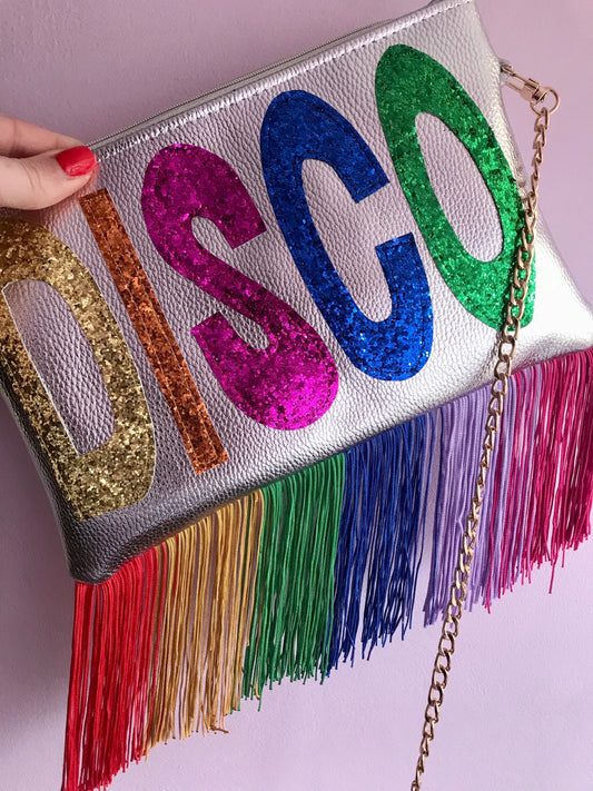 Silver clutch bag with glitter “DISCO” letters and rainbow fringe detail from Milo & Lily Boutique