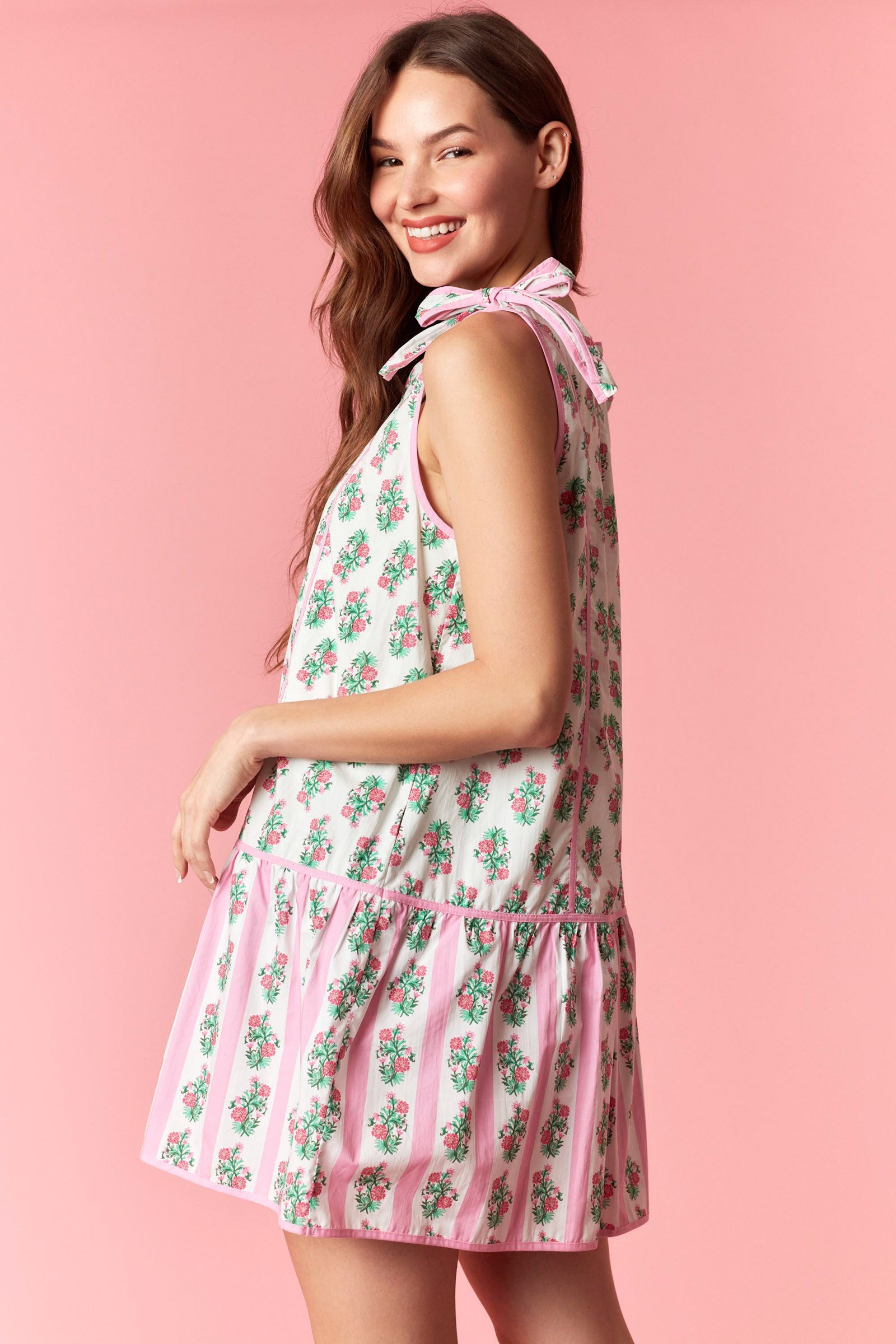 Pink floral tie shoulder mini dress with drop waist hem and pastel stripe detail