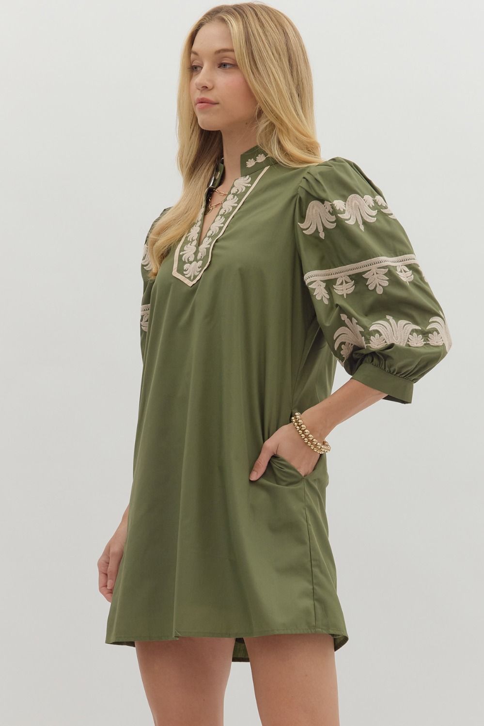 Side view of olive embroidered dress with neutral floral sleeves and pockets — elevated fall boutique look.
