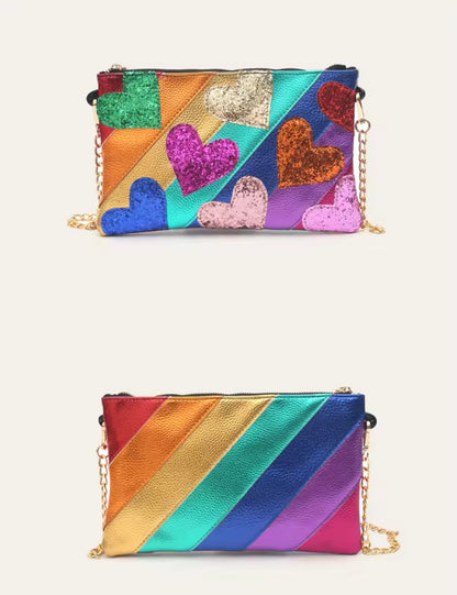 Colorful handbag with heart patterns and a rainbow-striped bag on a white background