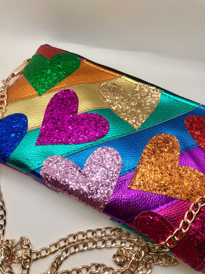 Multicolored purse with glittery heart designs on a white background