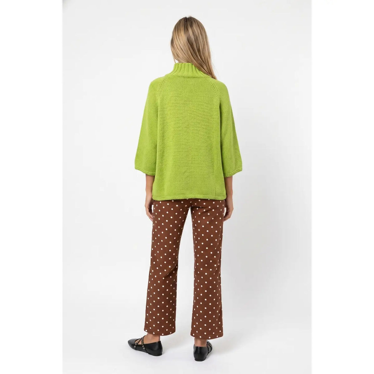 Back view of matcha green sweater showing relaxed silhouette and ribbed mock neck.