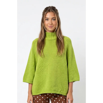 Front view of matcha green mock neck batwing sweater with three-quarter sleeves.