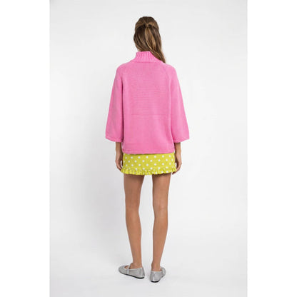 Back view of hibiscus pink mock-neck sweater showing relaxed fit and three-quarter sleeves.