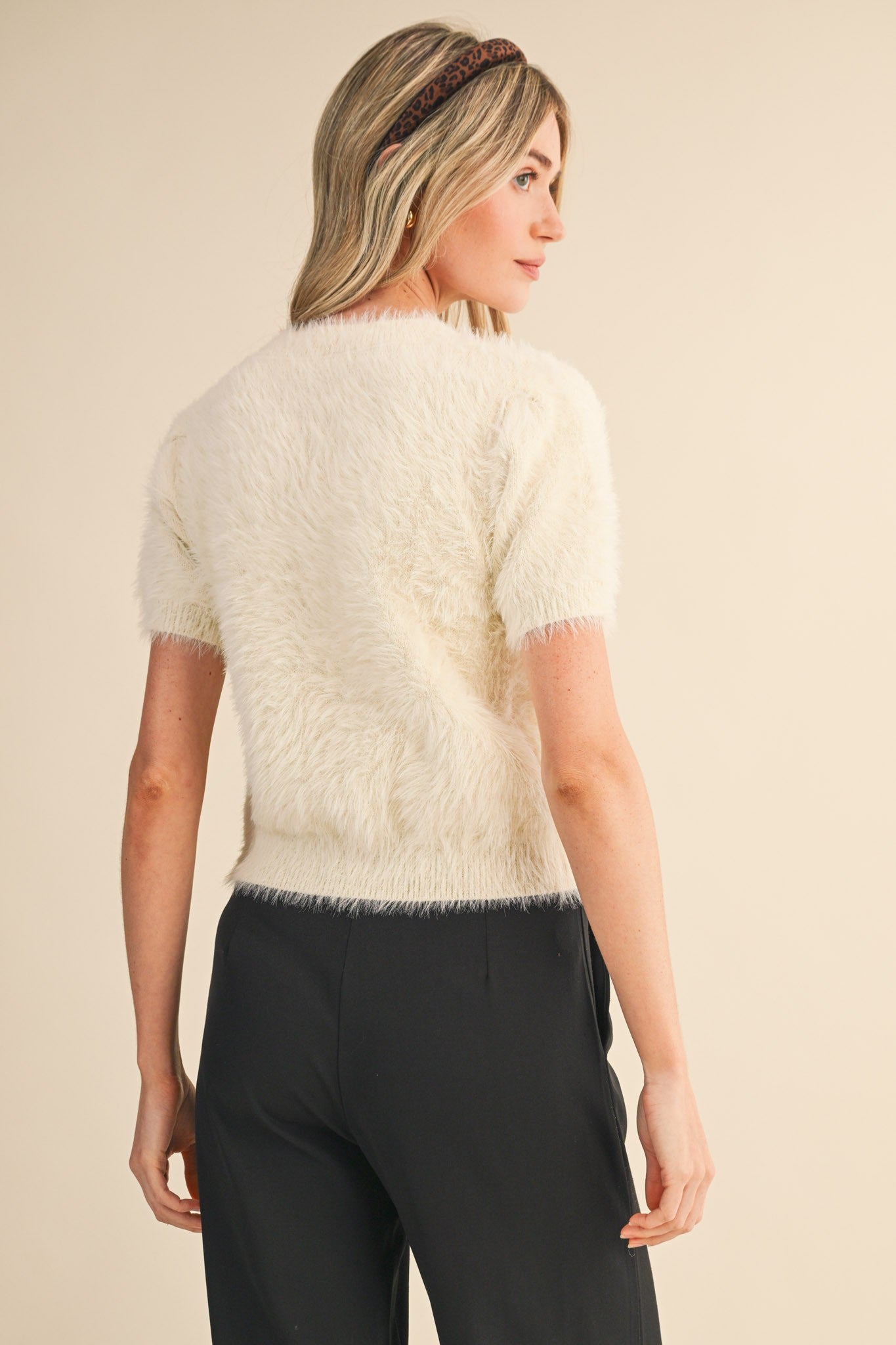 Back view of ivory fuzzy knit short sleeve top with soft eyelash texture