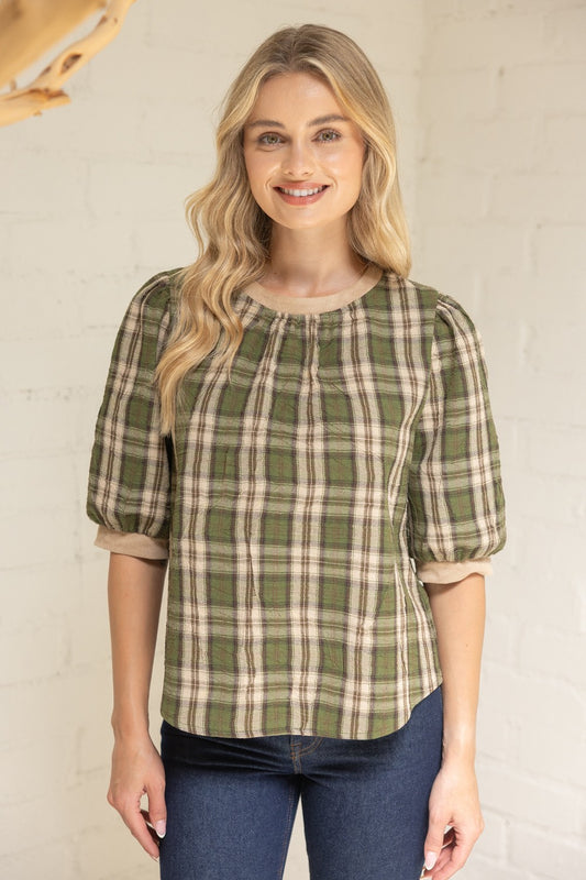 Model wearing green and beige plaid puff sleeve blouse with round neckline—front view