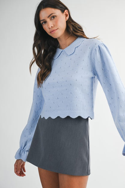 Model wearing a light blue scalloped hem knit sweater with puff sleeves and Peter Pan collar — feminine fall top from Milo & Lily Boutique.