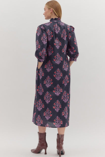 Back view of navy floral midi dress with romantic silhouette