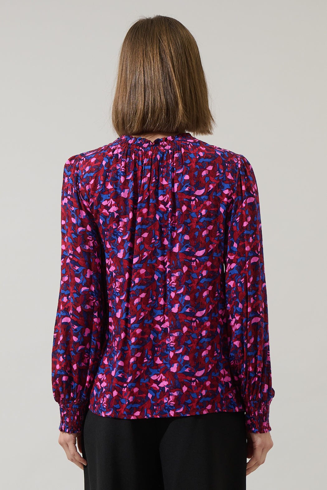 Back view of fuchsia and cobalt print long sleeve blouse