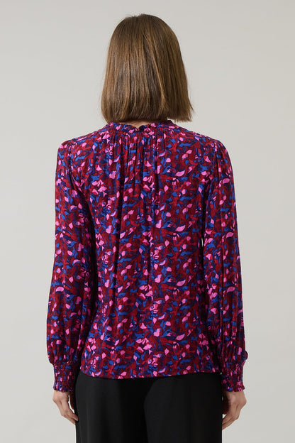 Back view of fuchsia and cobalt print long sleeve blouse