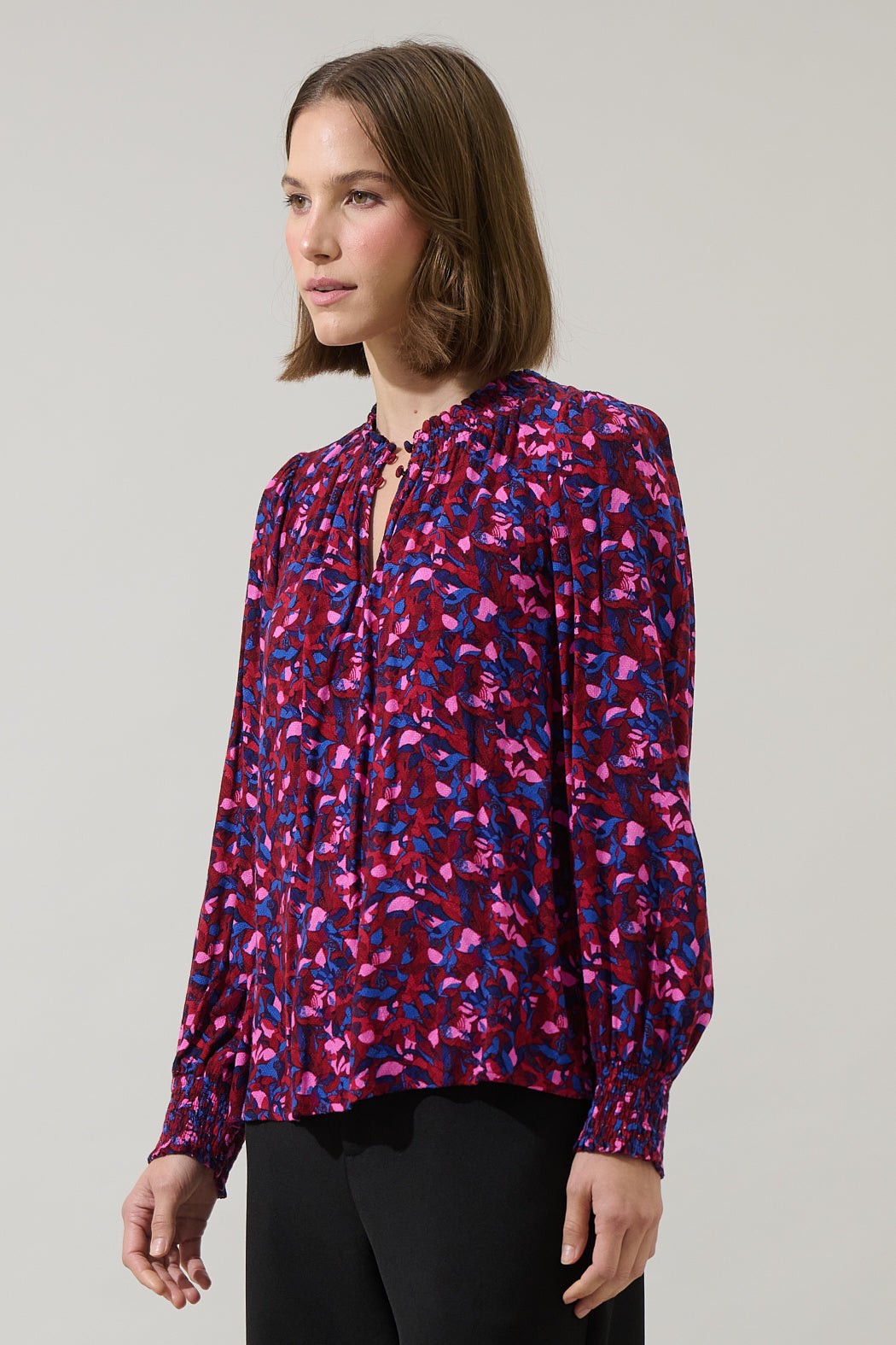 Side view of fuchsia and cobalt print long sleeve blouse