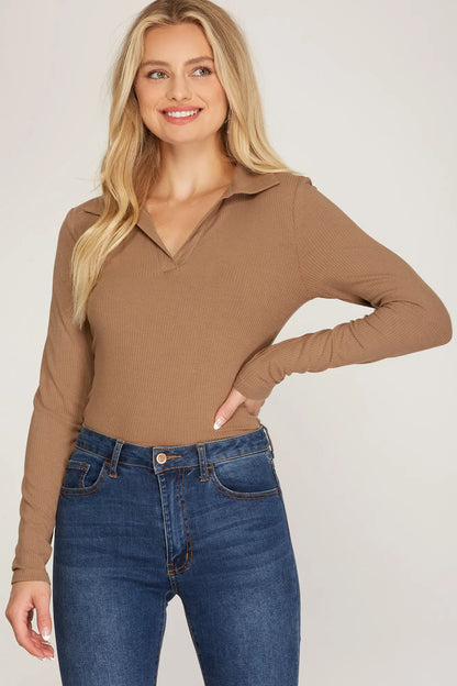 Woman wearing a ribbed brown collared bodysuit styled with high-waisted jeans – front view