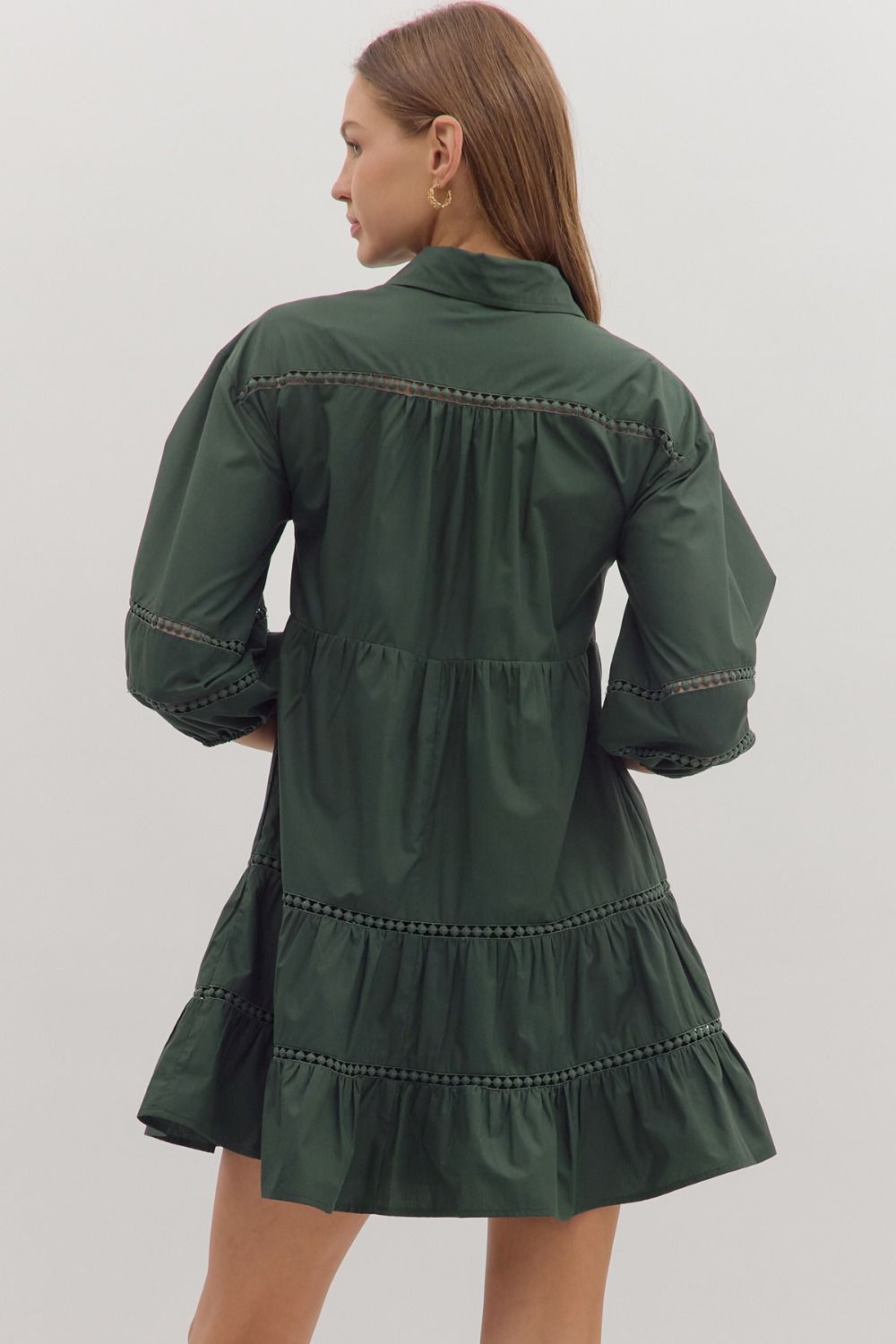 Back view of forest green tiered dress with feminine detailing
