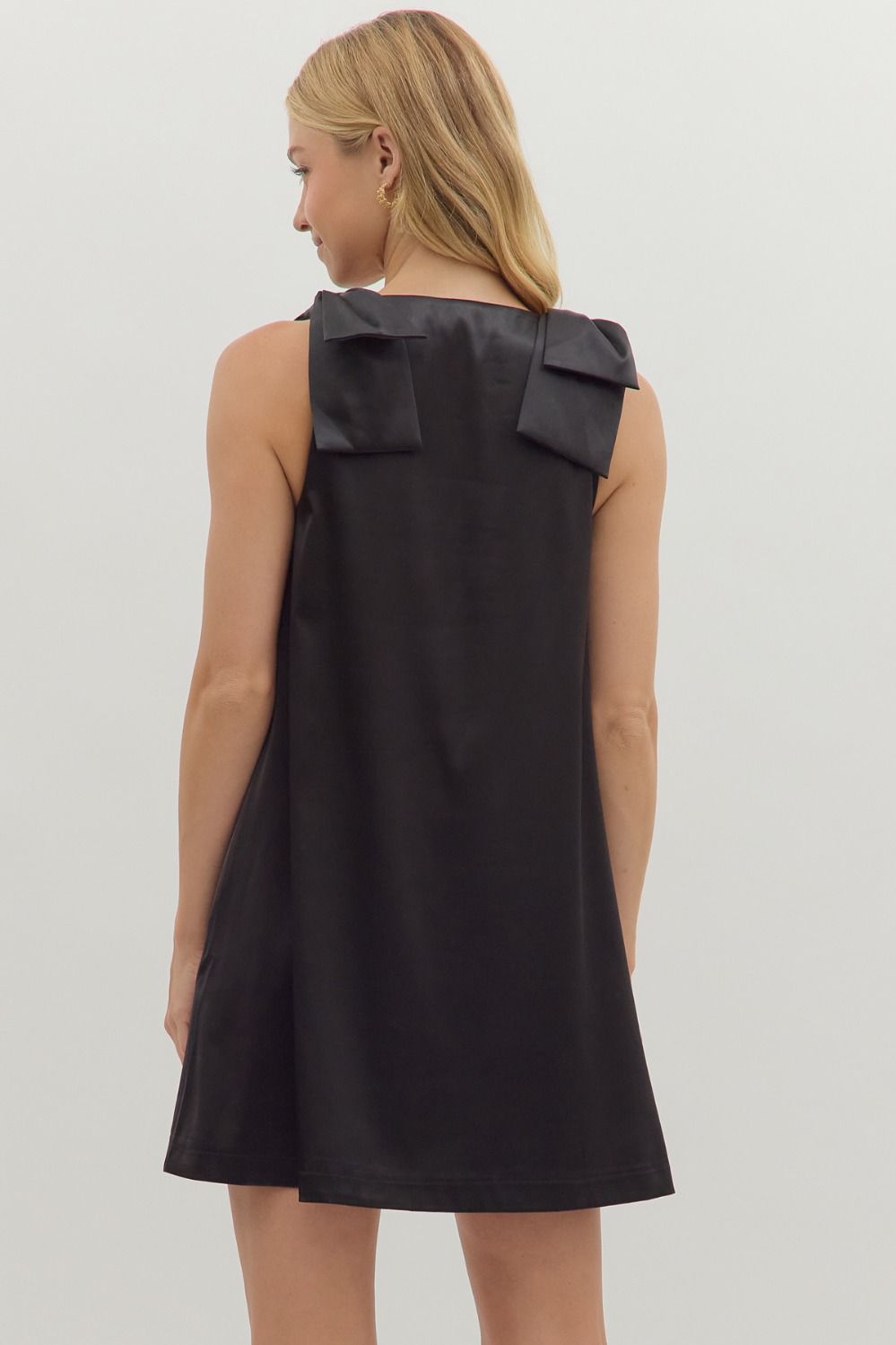 Back view of black satin dress with oversized shoulder bows