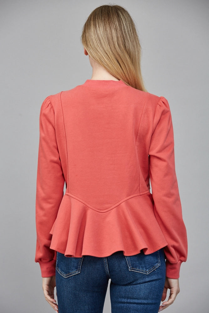 Back view of ruffled peplum hem top in coral