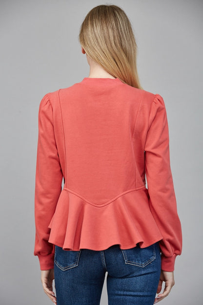 Back view of ruffled peplum hem top in coral