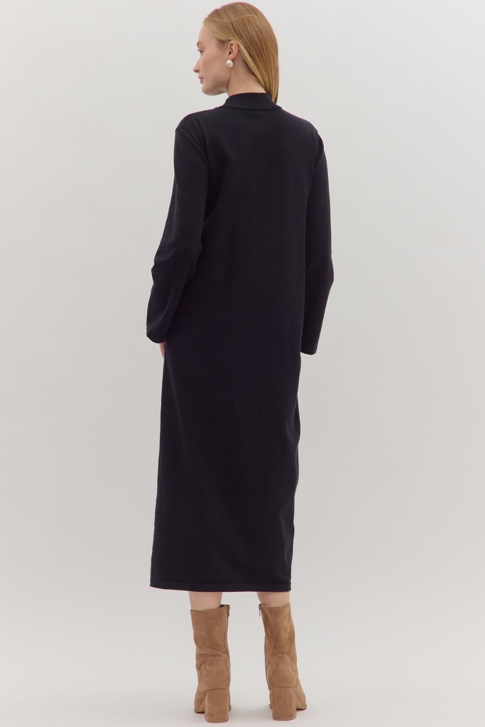 Back view of sleek black midi knit dress with minimalist silhouette
