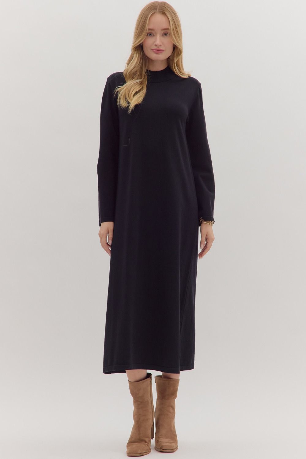 Front view of black knit midi sweater dress styled with tan suede boots
