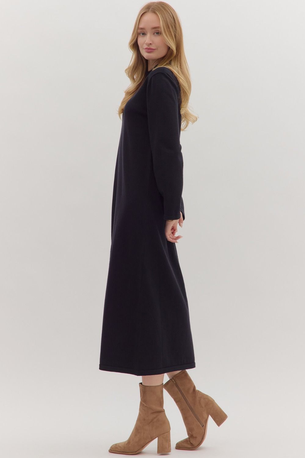 Side view of long sleeve mock neck sweater dress in black