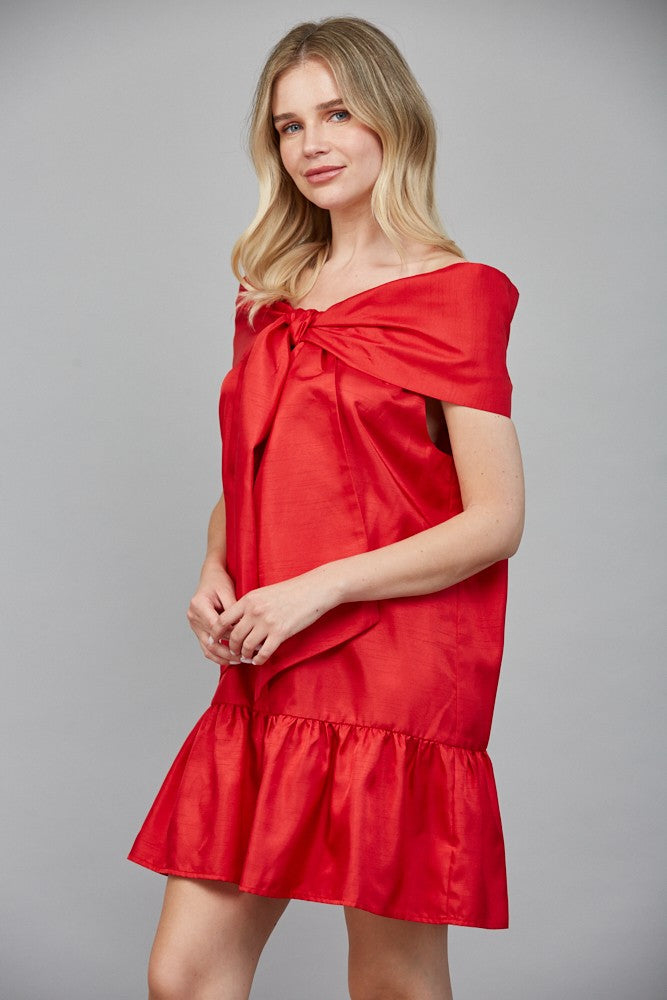 Side view of red bow front mini dress with ruffle hem