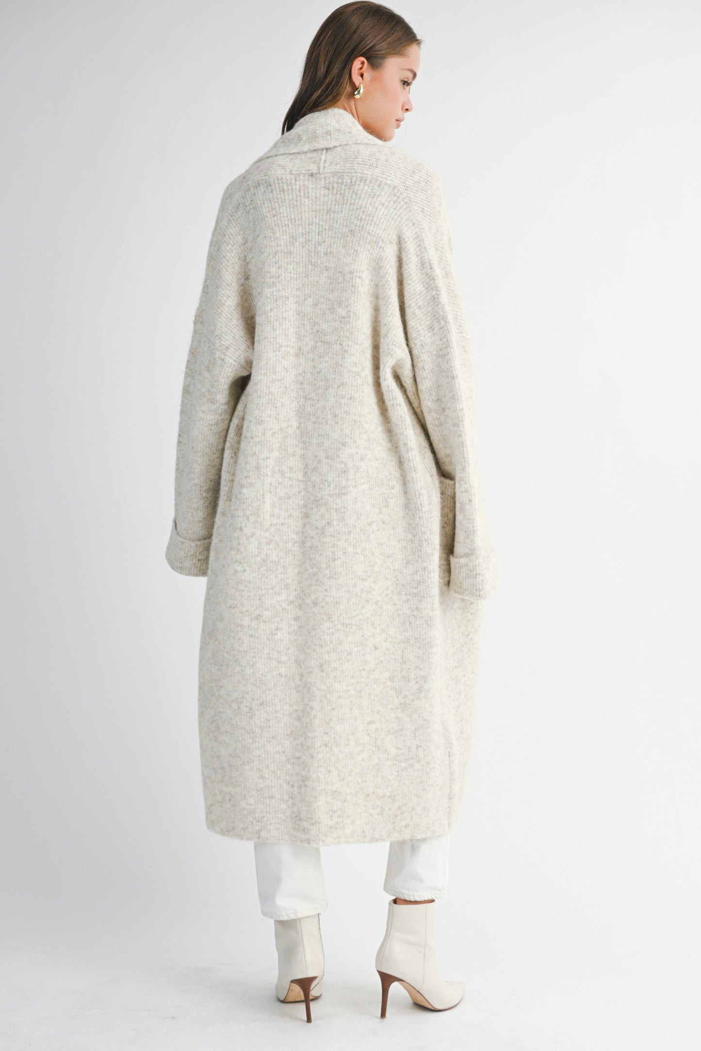 Back view of long neutral cardigan showing relaxed drape and soft texture