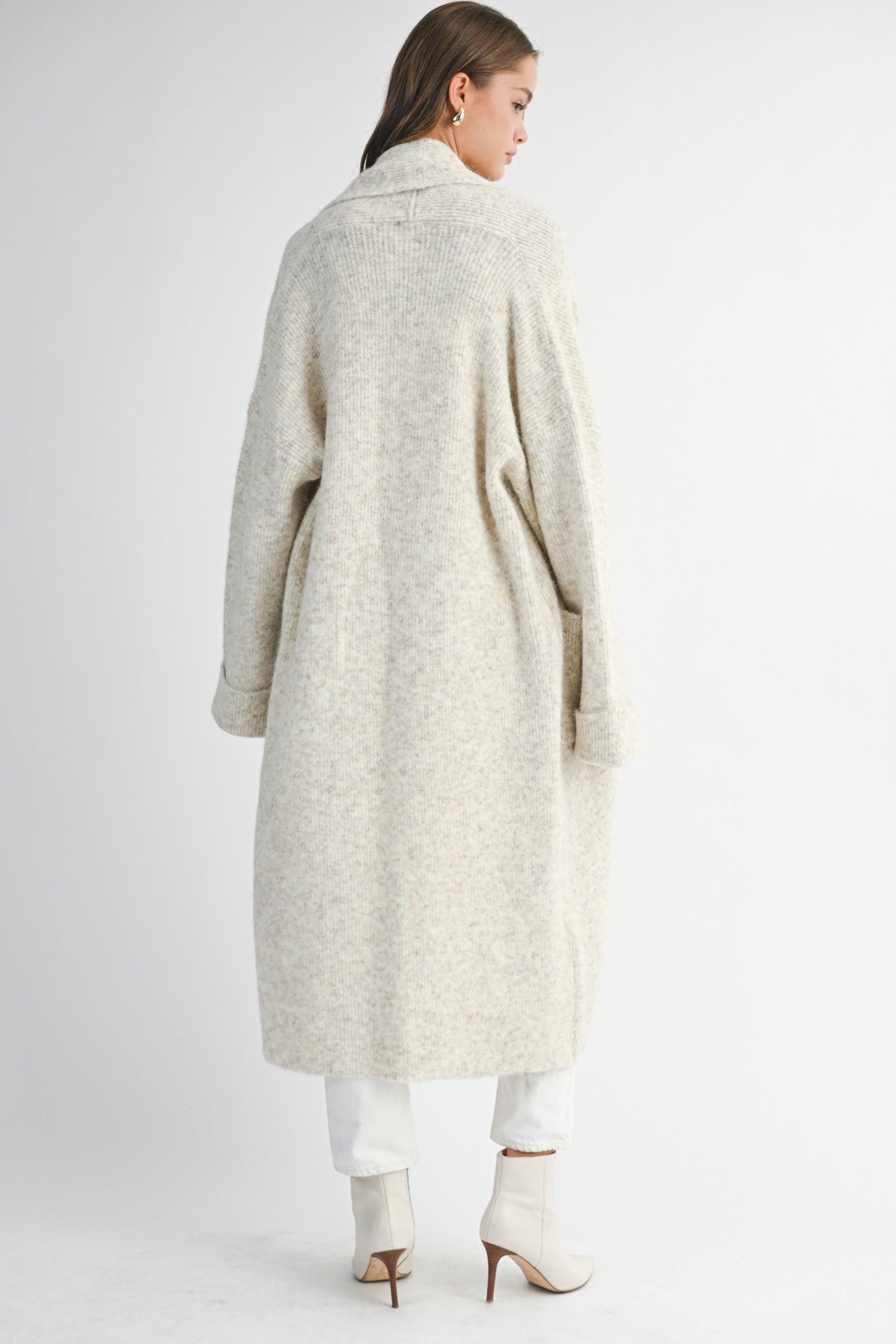 Back view of long neutral cardigan showing relaxed drape and soft texture
